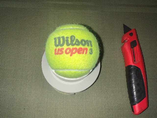 Tennis ball positioned with logo facing down