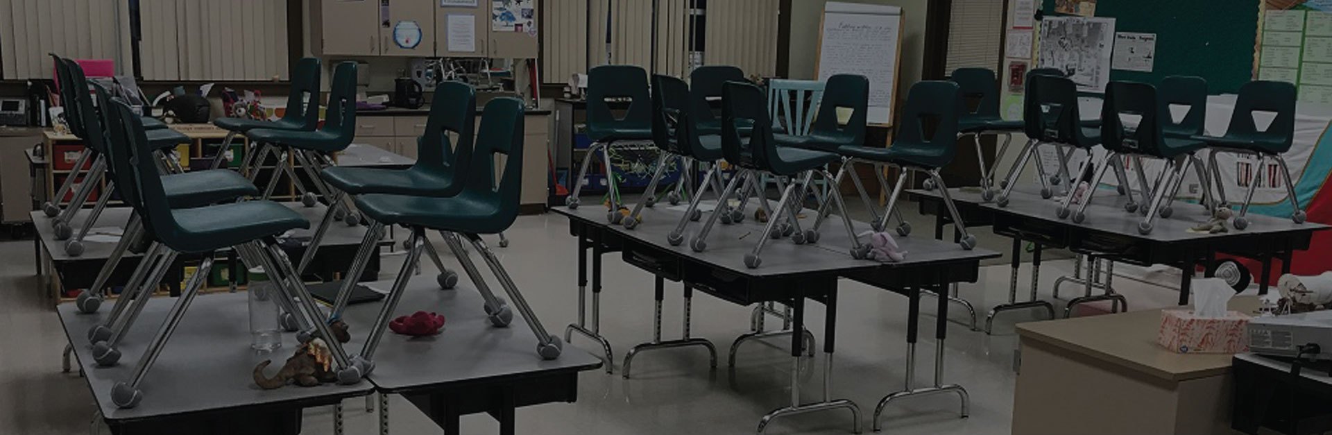 Classroom chairs with cut tennis balls installed on chair legs for noise reduction